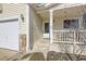 A view of the front porch with stone accents and exterior lights at 9617 Bighorn Way, Littleton, CO 80125