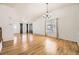 A large, naturally lit living room with hardwood flooring leading into other living spaces at 9617 Bighorn Way, Littleton, CO 80125