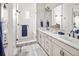 Bright bathroom features a glass shower, dual sinks, and modern black fixtures at 888 S Valentia St # 103, Denver, CO 80247