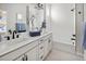 Well-lit bathroom with a double vanity, sleek black hardware, and a separate shower and tub at 888 S Valentia St # 103, Denver, CO 80247