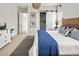 Comfortable bedroom with coastal-themed decor, barn door, and white walls at 888 S Valentia St # 103, Denver, CO 80247