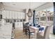 Sunlit dining area with a modern chandelier, table setting, and large windows offering views of the outdoors at 888 S Valentia St # 103, Denver, CO 80247