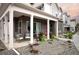 Inviting front porch of a townhouse featuring brick accents, a cozy seating area, and well-maintained landscaping at 888 S Valentia St # 103, Denver, CO 80247