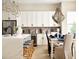 Bright kitchen with stainless steel appliances, white cabinets, and a marble island with pendant lights at 888 S Valentia St # 103, Denver, CO 80247