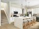 Well-lit kitchen with a large island, stainless steel appliances, and elegant pendant lighting, and stairs nearby at 888 S Valentia St # 103, Denver, CO 80247