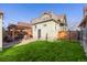 Private backyard featuring a pergola-covered seating area and lush green lawn at 4415 N Clay St, Denver, CO 80211