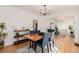 Open concept dining room with hardwood floors, and a view to the living room at 4415 N Clay St, Denver, CO 80211