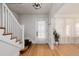 Bright entryway with hardwood floors and a staircase leading upstairs at 4415 N Clay St, Denver, CO 80211