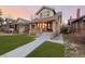 Brick craftsman home with a porch and steps leading to the entrance at 4415 N Clay St, Denver, CO 80211