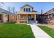 Charming brick home with a cozy front porch and well-manicured lawn at 4415 N Clay St, Denver, CO 80211