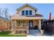 Traditional two-story home with a brick facade and inviting front porch at 4415 N Clay St, Denver, CO 80211