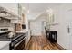 Modern kitchen with white cabinets, stainless steel appliances, and wood flooring at 4415 N Clay St, Denver, CO 80211