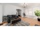 Bright living room features hardwood floors, comfortable seating, and a stylish chandelier at 4415 N Clay St, Denver, CO 80211