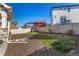Fenced backyard featuring well maintained landscaping and a stone pathway at 4104 N Picadilly Ct, Aurora, CO 80019