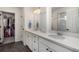 Beautifully designed bathroom featuring dual sinks, vanity storage, and a walk-in closet at 4104 N Picadilly Ct, Aurora, CO 80019