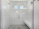 Modern glass enclosed shower featuring subway tile and a comfortable built-in bench at 4104 N Picadilly Ct, Aurora, CO 80019