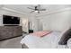 Relaxing bedroom featuring a dresser with TV and a comfortable king-size bed at 4104 N Picadilly Ct, Aurora, CO 80019