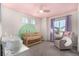 Charming Bedroom with pink ceiling, rocking chair, crib, and plenty of natural light at 4104 N Picadilly Ct, Aurora, CO 80019