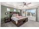 Spacious bedroom featuring a ceiling fan, natural light, and a stylish accent wall at 4104 N Picadilly Ct, Aurora, CO 80019
