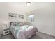 Bright bedroom features a beach-themed decor and soft, inviting bedding at 4104 N Picadilly Ct, Aurora, CO 80019