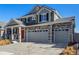 Lovely two-story home featuring stone accents, inviting front porch, and a grey two car garage at 4104 N Picadilly Ct, Aurora, CO 80019