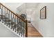 Elegant foyer with wood floors, iron staircase, and decorative wall art at 4104 N Picadilly Ct, Aurora, CO 80019