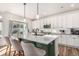 Bright kitchen with a quartz island, a stainless steel range, and modern barstool seating at 4104 N Picadilly Ct, Aurora, CO 80019