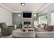 Bright living room features a gray fireplace and a comfortable sectional sofa with stylish accent pillows at 4104 N Picadilly Ct, Aurora, CO 80019