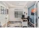 Modern home office featuring blue accent wall, bright window, desk, and stylish rug at 4104 N Picadilly Ct, Aurora, CO 80019