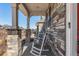 Cozy front porch with white columns, stone accents, and relaxing rocking chairs at 4104 N Picadilly Ct, Aurora, CO 80019