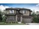 Two story home with a neutral color palette, stone accents, a covered porch and a two car garage at 7426 S Yank Ct, Littleton, CO 80127