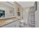 Bathroom featuring a single vanity with granite countertops, a mirror, and a bathtub with shower at 7672 S Ensenada Ct, Centennial, CO 80016