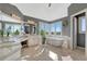 Bright bathroom featuring double vanity sinks, a standalone tub, and gorgeous natural light from the large picture windows at 7672 S Ensenada Ct, Centennial, CO 80016