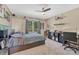 Bedroom with a large window, ceiling fan, carpeted floor, and bed with storage underneath at 7672 S Ensenada Ct, Centennial, CO 80016