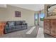 Bedroom featuring a cozy seating area, dresser, soft carpeting, natural light and custom artwork at 7672 S Ensenada Ct, Centennial, CO 80016