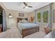 Bedroom featuring a bed, ceiling fan, large window, and a closet in view at 7672 S Ensenada Ct, Centennial, CO 80016