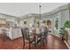 Bright dining area featuring a view to the kitchen with tile backsplash and breakfast bar at 7672 S Ensenada Ct, Centennial, CO 80016