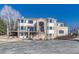 Elegant two-story home boasting a brick facade, balcony, and impressive entrance, set against a clear blue sky at 7672 S Ensenada Ct, Centennial, CO 80016