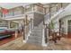 Grand foyer showcases a sweeping staircase with dark wood railings, and stone tile leading to the living spaces at 7672 S Ensenada Ct, Centennial, CO 80016