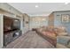 Comfortable living area featuring custom built-ins, entertainment center and a rustic wood accent wall at 7672 S Ensenada Ct, Centennial, CO 80016