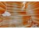 Relaxing sauna interior with wood paneled walls and bench, along with a bucket and towels at 7672 S Ensenada Ct, Centennial, CO 80016