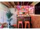 Basement bar with colorful decor, seating, and a tropical theme at 6567 S Elizabeth Way, Centennial, CO 80121