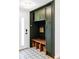 Mudroom entryway features an organizer, a wooden bench, and patterned tile flooring at 6567 S Elizabeth Way, Centennial, CO 80121
