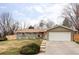 Charming home with a well-maintained lawn, flower pots, and a two-car garage at 6567 S Elizabeth Way, Centennial, CO 80121