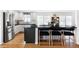Modern kitchen features an eat-in island with seating and stainless steel appliances at 6567 S Elizabeth Way, Centennial, CO 80121