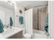 Bright bathroom with a tiled shower/tub and a modern vanity at 3333 Osage St, Denver, CO 80211