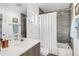 Bathroom featuring modern vanity, a large mirror, and a shower-tub combination with tiled walls at 3333 Osage St, Denver, CO 80211