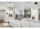 Modern bathroom with double sinks, soaking tub, and large mirror at 3333 Osage St, Denver, CO 80211