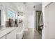 Bright bathroom featuring a soaking tub, dual vanity, and a glass-enclosed shower for a spa-like experience at 3333 Osage St, Denver, CO 80211