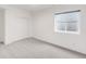 Clean bedroom with carpet floors, window, and sliding closet doors at 3333 Osage St, Denver, CO 80211
